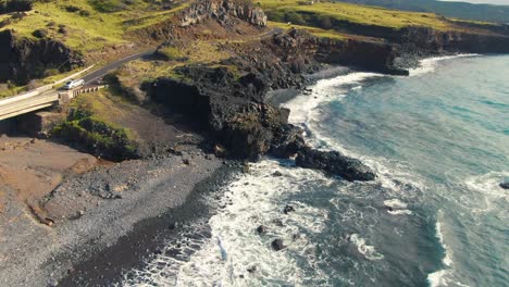 Road-to-Hana-and-sea-cave-nearby,-Hawaii-island,-aerial-drone-view
