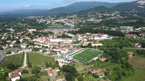 Aerial-Ponte-de-Lima-football-stadium-pitch,-oldest-village-in-Portugal