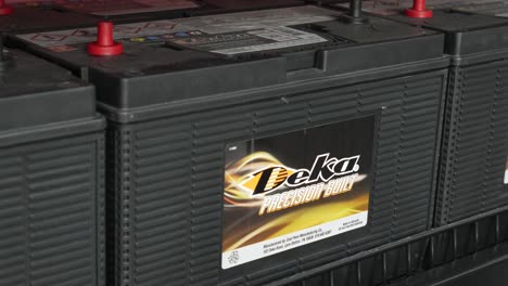 Car-batteries-of-the-American-brand-Deka-on-the-shelf-of-a-distributor-store