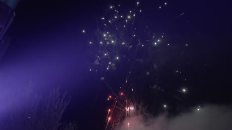 People-enjoying-fireworks-being-shoot-up-the-sky-and-exploding-at-social-event-in-France