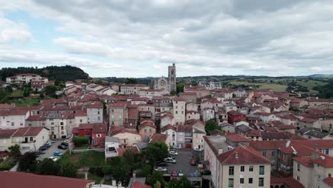drone-shot-going-backward-over-Saint-Galmier-in-Loire-Departement,-the-city-is-known-to-be-home-of-Badoit-sparkling-water,-region-auvergne-rhone-alpes,-France