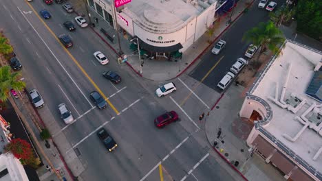 Drone-Footage-of-Busy-Intersection-in-Studio-City-Los-Angeles,-Cars-and-Businesses-Below