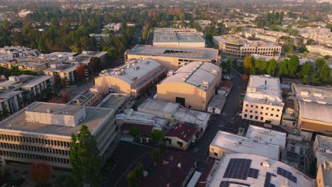 Bright-Sunny-Backlot-and-Soundstages-at-CBS-Radford-in-Los-Angeles,-Drone-Flying-Over-Historic-Studio-and-Neighboring-Community