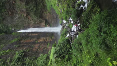Vertical-format-aerial-approaches-powerful-green-Karas-Biru-waterfall