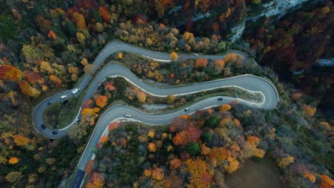 aerial-view-taken-with-drone-over-the-lacets-de-septmoncel,-winding-road-in-jura-departement,-bourgogne-franche-comte-region-during-autumn,-french-countryside