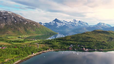 Scenic-road-on-the-coast-of-northern-Norway-with-mountains,-sea-and-settlement