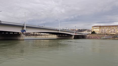 Tramway-Crossing-Lyon's-Bridge-Over-the-Flowing-River,-Offering-a-Scenic-Journey-Through-the-Heart-of-France