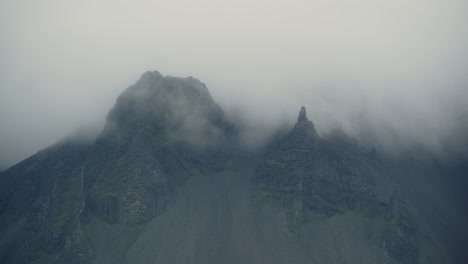 Clouds-roll-through-jagged-mountain-peaks-in-Iceland-on-a-stormy-day