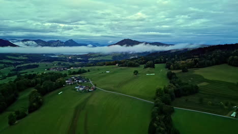 Aerial-panning-view-of-morning-clouds-in-the-valley-between-the-Alps-in-Austria