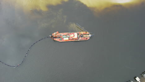 Drone-shot-of-dredging-happening-in-the-intercostal-waterway,-downward-angle-aerial-shot