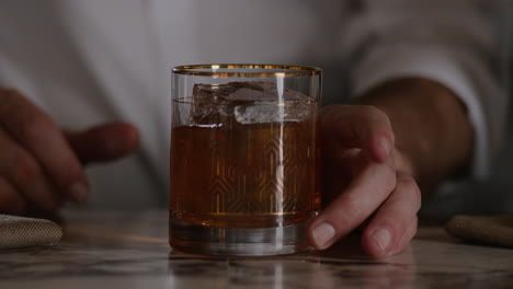 Bartender-garnishes-an-old-fashioned-with-a-cherry