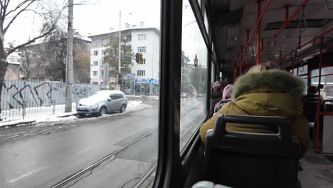 POV-footage-from-inside-tram-number-22,-on-a-bright-winter-day,-a-woman-gets-up-from-her-seat