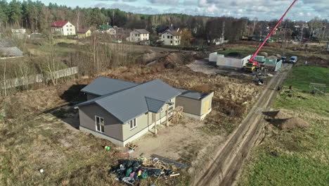 Drone-dolley-shot-of-new-builded-villa-with-in-the-background-construction-work