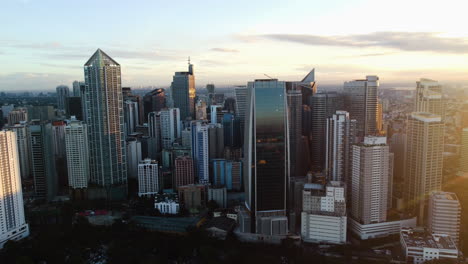 Drone-shot-of-Makati-city,-urban-business-city-in-the-financial-center-of-the-Philippines