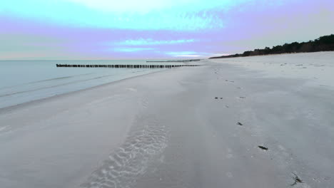 An-empty,-lonely-beach-on-the-Baltic-Sea-on-the-Darß-peninsula,-only-one-person-can-be-seen-in-the-distance
