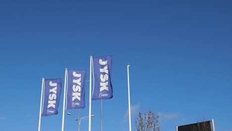 Banner-flags-of-Jysk-store-waving-in-wind,-the-shop-sells-houseware