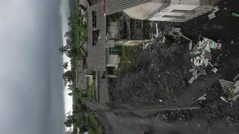Vertical-format:-Motos-ride-through-village-damaged-by-volcanic-ash