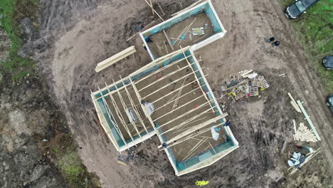 Top-down-drone-lifting-shot-of-roof-construction-of-a-large-villa