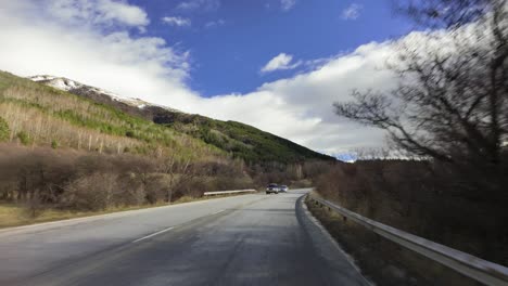 passing-by-cars-on-the-sub-Balkan-road-E871,-the-Balkan-mountains-can-be-seen-on-the-left
