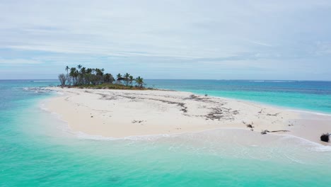 Drone-Shot,-Small-Uninhabited-Coral-Island-With-White-Sand-and-Palm-Trees,-Tonga-Polynesia