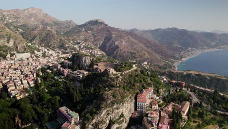 Drone-flying-over-Taormina,-Sicily-during-golden-hour