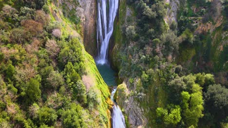 Drone-shot-flying-over-a-waterfall-while-panning-up-near-Tivoli,-Italy