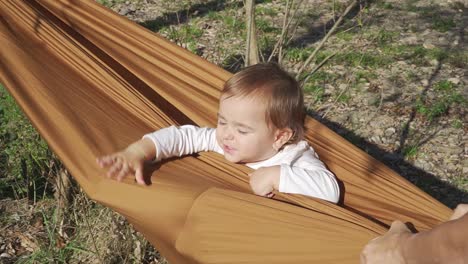 Close-up-view-of-little-girl-swinging-in-hammock