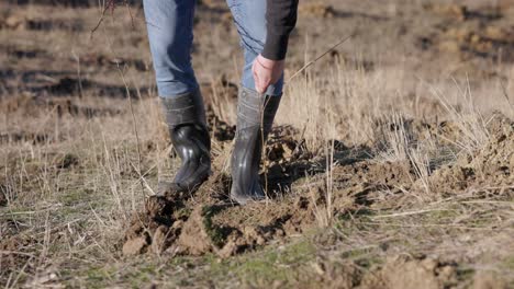 A-Man-in-Boots-Compacting-the-Soil-with-His-Feet---Close-Up