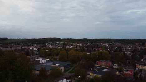 Reveal-of-Valkenburg-township-in-Netherlands,-aerial-drone-ascend-view