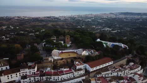 Catholic-church-and-bull-arena-in-Mijas-town,-aerial-view