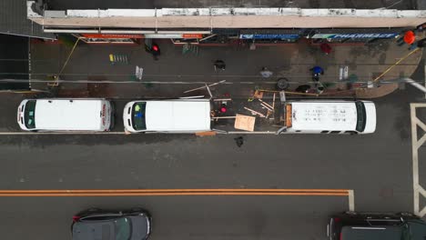 A-top-down,-aerial-view-of-the-aftermath-of-a-multi-alarm-fire-of-businesses-on-a-cloudy-day