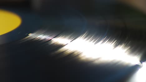 Close-Up-of-a-Spinning-Vinyl-Sun-Reflection
