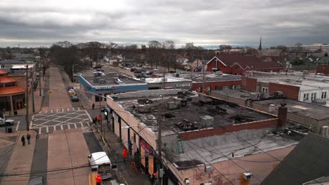 An-aerial-view-of-the-aftermath-of-a-multi-alarm-fire-of-businesses-on-a-cloudy-day