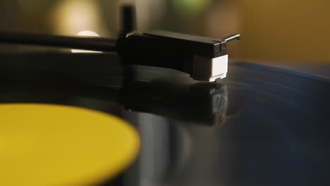 Close-Up-of-the-Headshell-of-a-Record-Player-while-a-Vinyl-is-Spinning