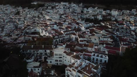 White-building-of-Mijas-vilalge-in-Spain-after-sunsnet,-aerial-view