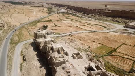 Fly-over-historical-castle-in-silk-road-izadkhast-village-in-fars-one-of-the-largest-adobe-building-in-the-world-ancient-fortress-resistance-enemy-sassanid-old-traditional-architecture-Iran-landscape