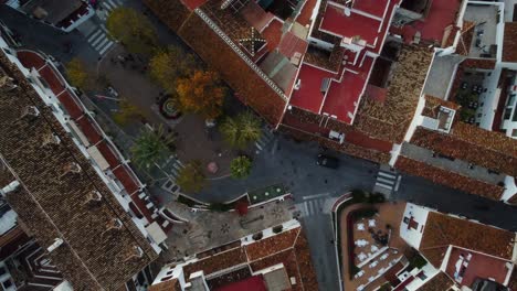 Central-street-of-Mijas-township-with-red-rooftops,-aerial-top-down-view