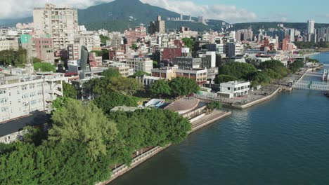 Tamsui-Riverside-View-with-City-and-Mountain-Backdrop,-Taiwan,-Republic-of-China,-Aerial