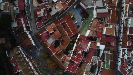 Red-clay-tiles-rooftops-of-Mijas-township,-aerial-top-down-view