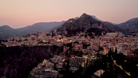 Aerial-drone-shot-over-Taormina-after-sunset-in-Sicily-island