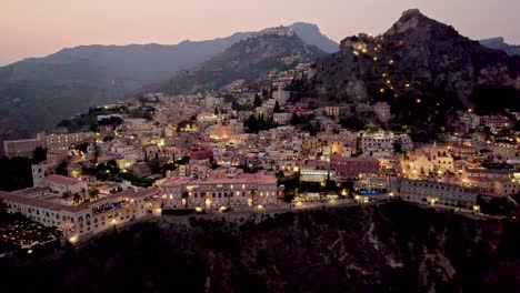 Aerial-drone-shot-over-Taormina-after-sunset-in-Sicily-island