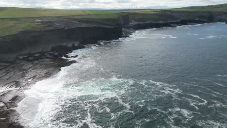 Aerial-forward-over-Irish-rocky-Kilkee-cliffs,-County-Clare-in-Ireland