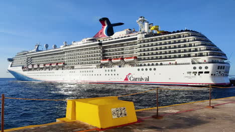 Experience-the-grandeur:-magnificent-Carnival-cruise-ship-rests-gracefully-at-port-in-Mexico,-radiating-vibrant-colors-and-excitement