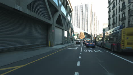 POV-shot-driving-on-the-streets-of-Manhattan,-sunny-day-in-New-York