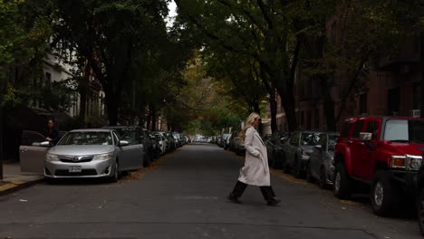 Woman-crossing-small-neighborhood-street-in-New-York-City