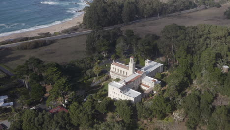 4K-cinematic-aerial-rotation-around-the-Carmelite-Monastery-with-the-Pacific-Coast-Highway-and-Monastery-Beach-in-the-background