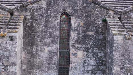 Abbaye-de-Vignogoul's-external-weathered-elegance-with-stained-glass-window