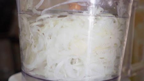 Slow-motion-closeup-of-a-food-processor-chopping-onion
