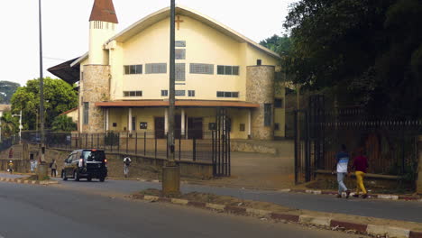 Tráfico-Frente-Al-Templo-Del-Cincuentenario,-Día-Soleado-En-Yaundé,-Camerún