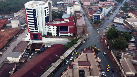 Drone-tilting-over-streets-in-downtown-Yaounde,-rainy-day-in-Cameroon,-Africa
